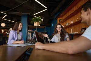 Friendly office team discussing workflow at a table in office