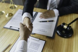 Lawyers shake hands with business people to seal a deal with partner lawyers. or a lawyer discussing